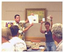 68 Mary Bowman & Husband Displaying Raffle Prizes